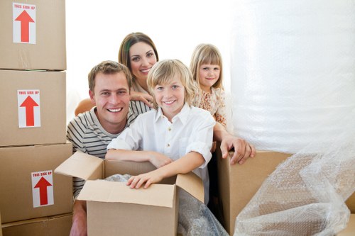 Helper carrying furniture for a flat move near Lampton