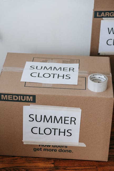 A row of seven light green, blank paper tags hang from thin white strings against a black background. The tags are evenly spaced with the strings attached to the top center of each. One of the tags, s